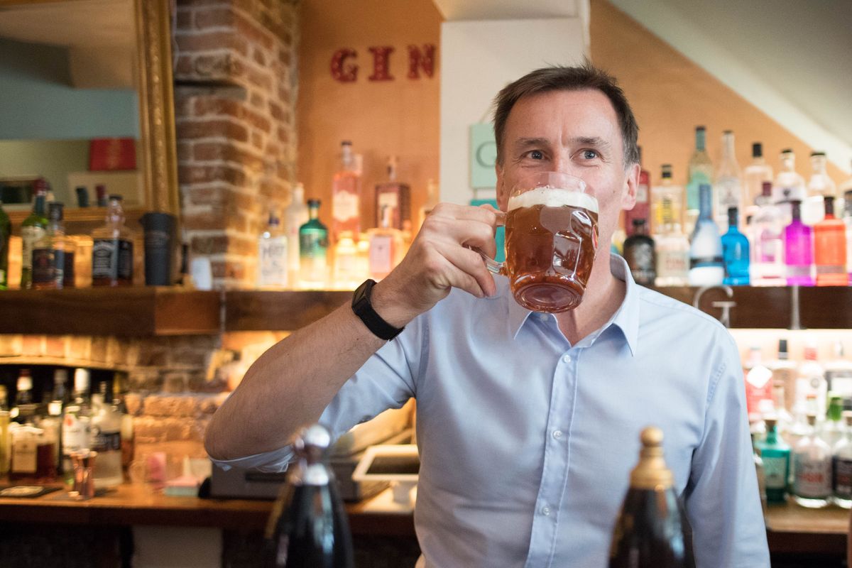 Jeremy Hunt pulls a pint at The Keep pub in Guildford, Surrey