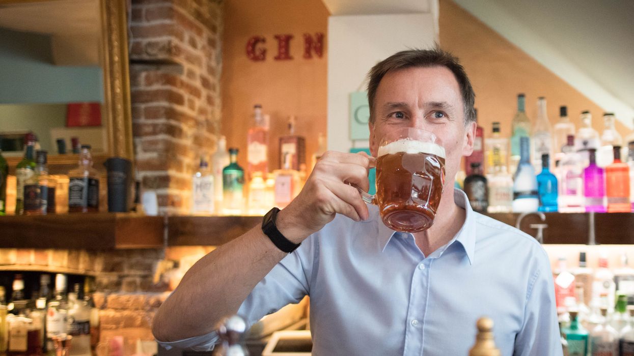 Jeremy Hunt pulls a pint at The Keep pub in Guildford, Surrey