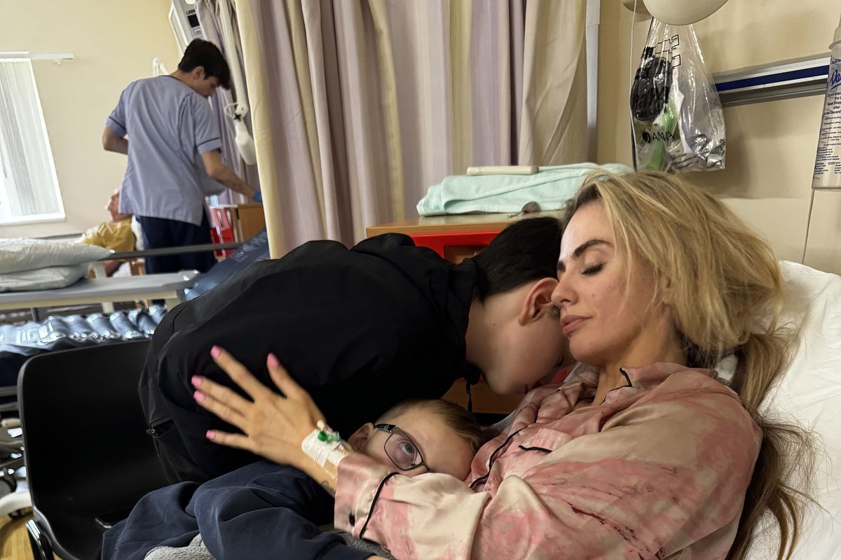 Jess Tierney, 29, comforted by her kids as she recovers from having a stroke in hospital