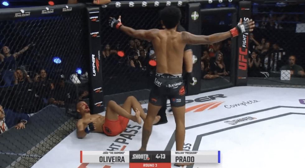 Joao Oliveira pleaded with the referee to end the contest but he did not move