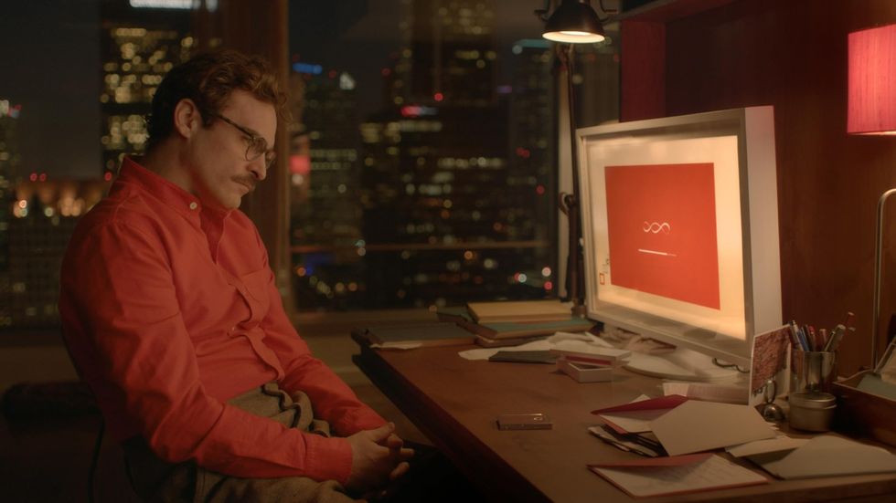 Joaquin Phoenix is pictured sitting in front of his computer talking to an AI chatbot in the film Her