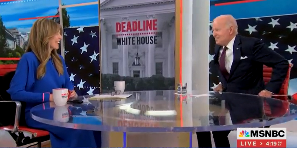 Joe Biden getting out of his chair while cameras continue to film