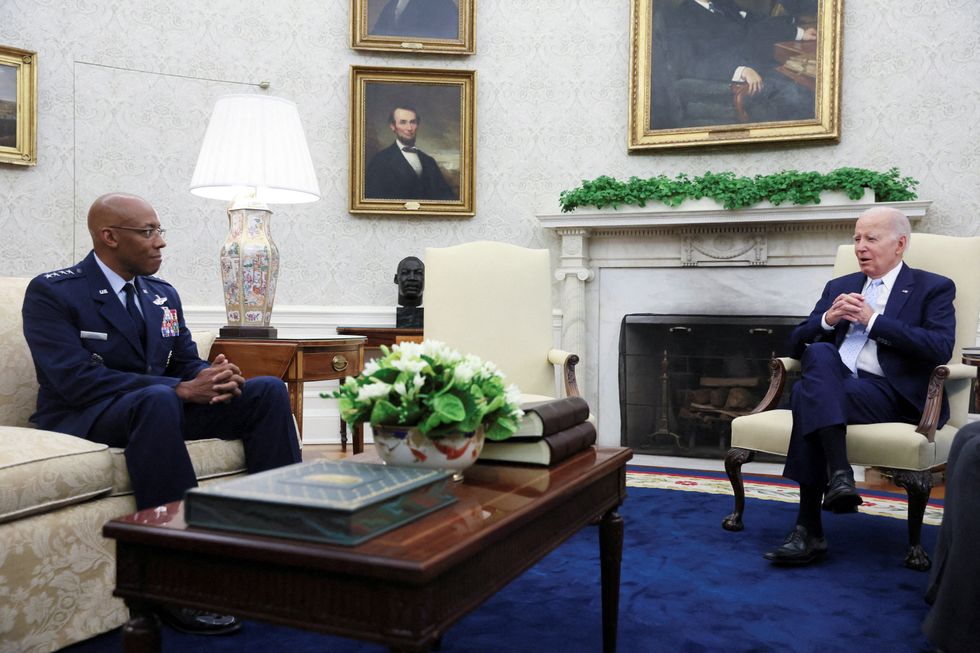 Joe Biden speaks to Chairman of the Joint Chiefs of Staff Air Force General Charles Q. Brown Jr.