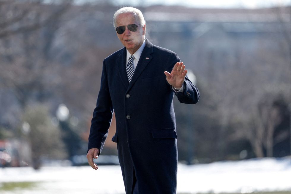 Joe Biden waves towards the media after landing on the South Lawn of the White House in Washington