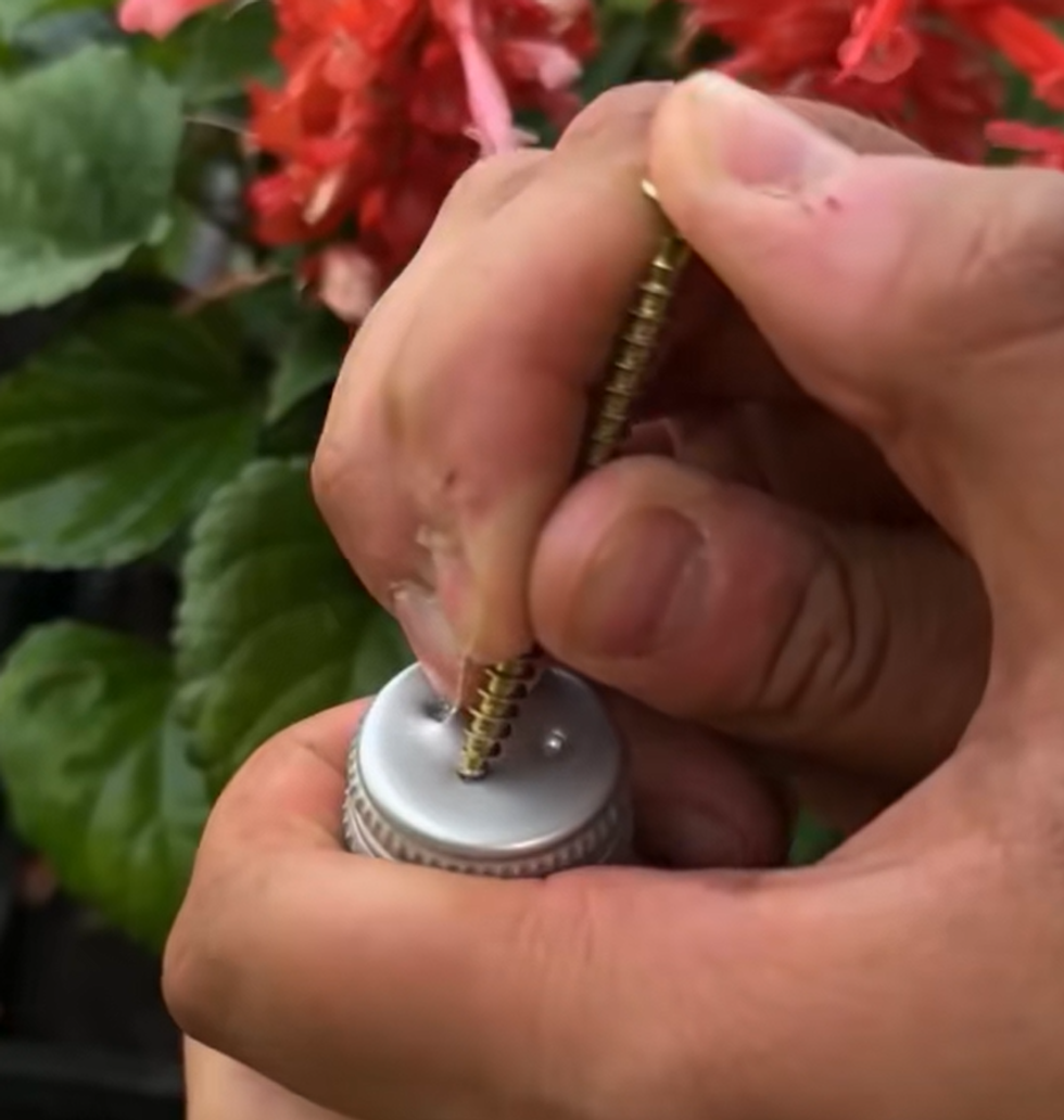 Joe poking a hole in a bottle cap