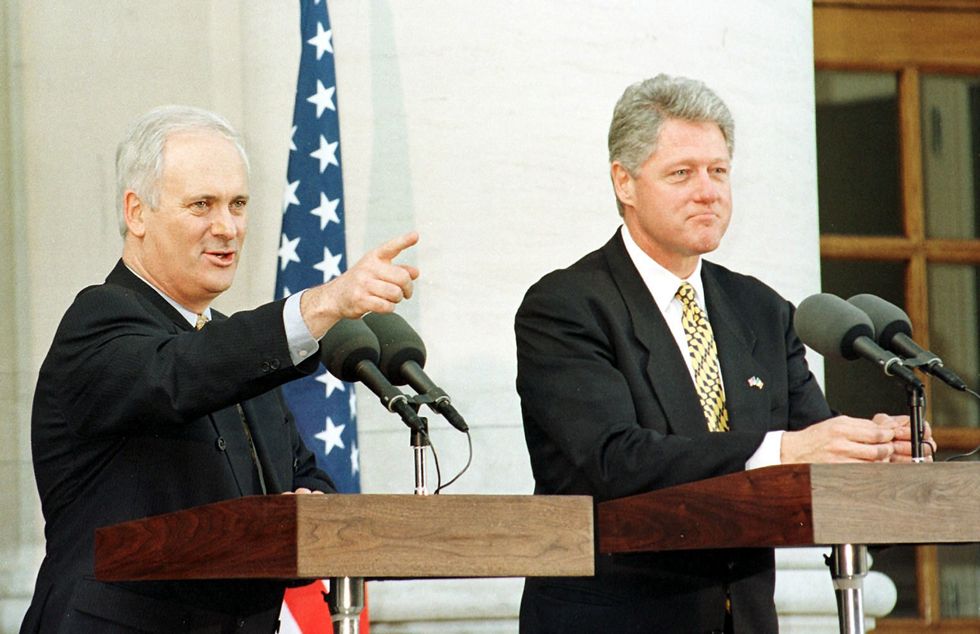 John Bruton giving a speech with former President Bill Clinton