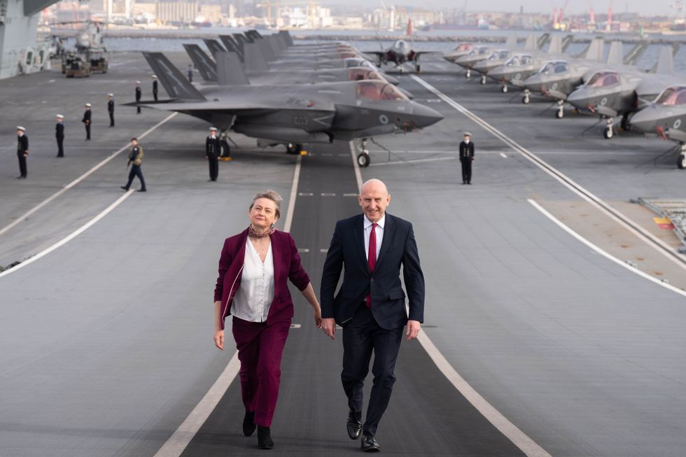 John Healey and Yvette Cooper on the deck of the HMS Prince of Wales