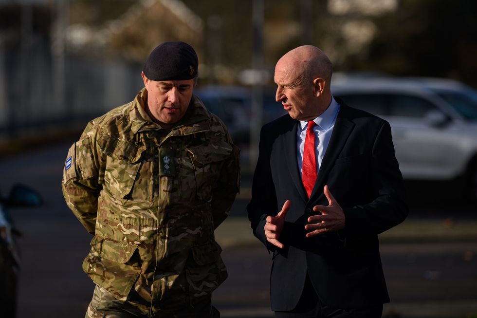 John Healey speaking with a member of the Armed Forces