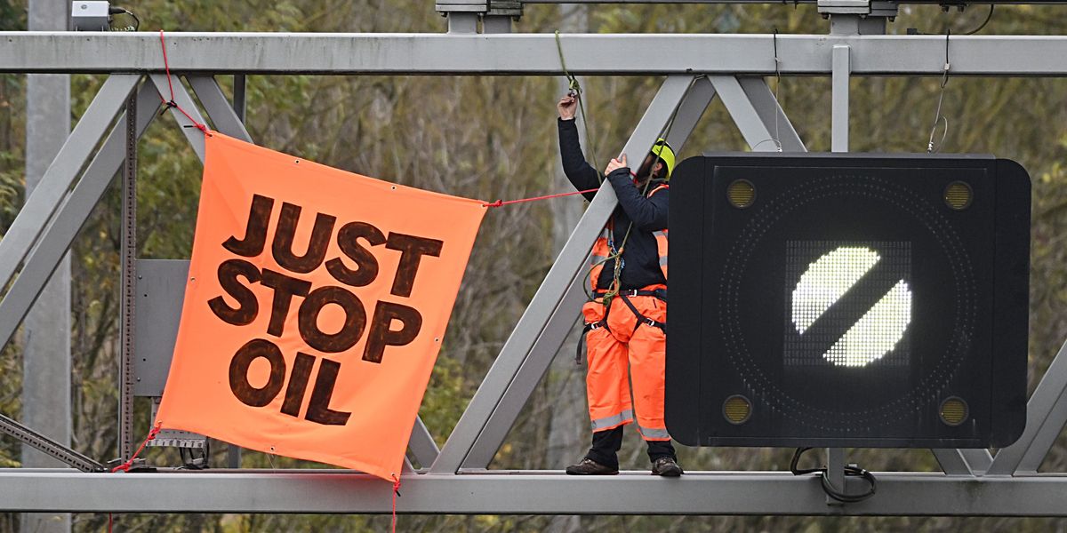 NextImg:Just Stop Oil activists smile and blow kisses as they're jailed for protesting on M25