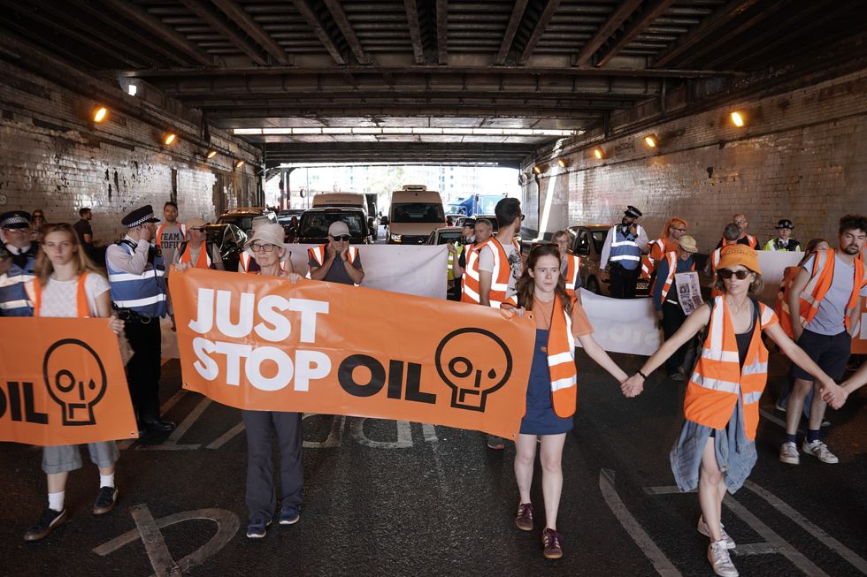Just Stop Oil activists take part in slow walk protest in Vauxhall, central London