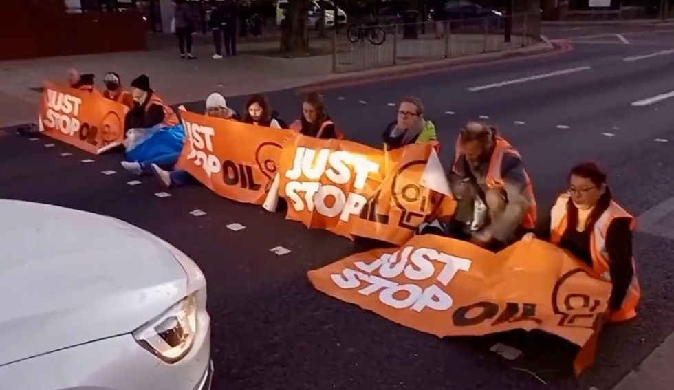 Just Stop Oil protesters are stationed near Baron's Court station.