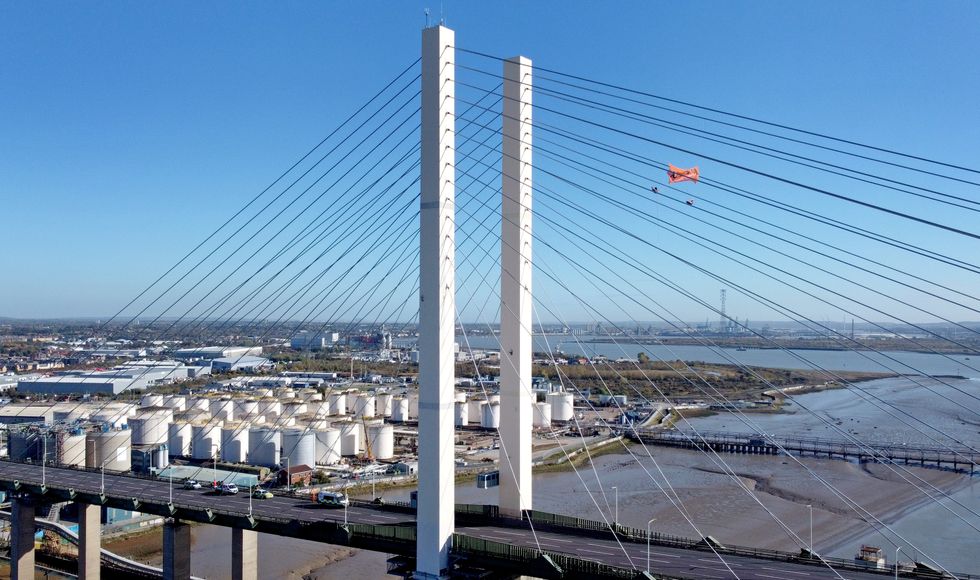 Just Stop Oil protesters continue their protest for a second day on the Queen Elizabeth II Bridge, which links Kent and Essex and which remains closed for traffic, after it was scaled by two climbers from the group. Picture date: Tuesday October 18, 2022.