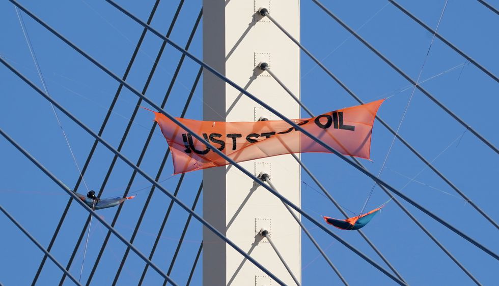 Just Stop Oil protesters continue their protest for a second day on the Queen Elizabeth II Bridge, which links Kent and Essex and which remains closed for traffic, after it was scaled by two climbers from the group. Picture date: Tuesday October 18, 2022.