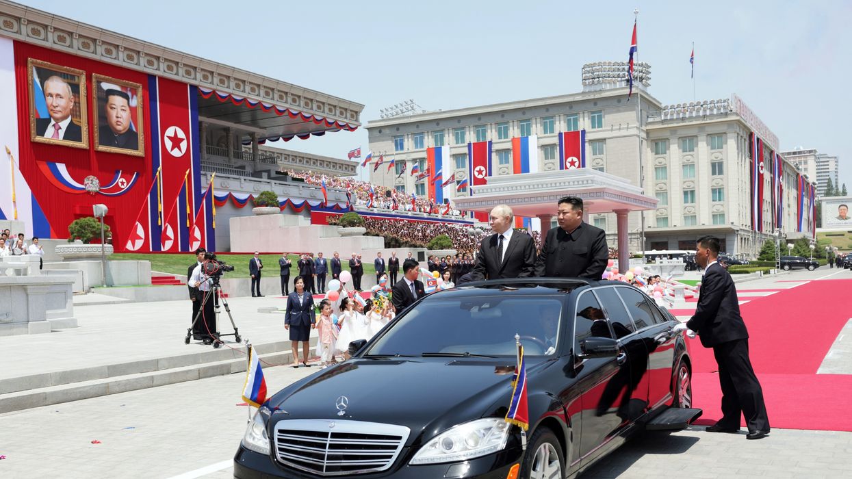 k, North Korea's leader Kim Jong Un (R) and Russian President Vladimir Putin attend a welcoming ceremony at Kim Il Sung Square