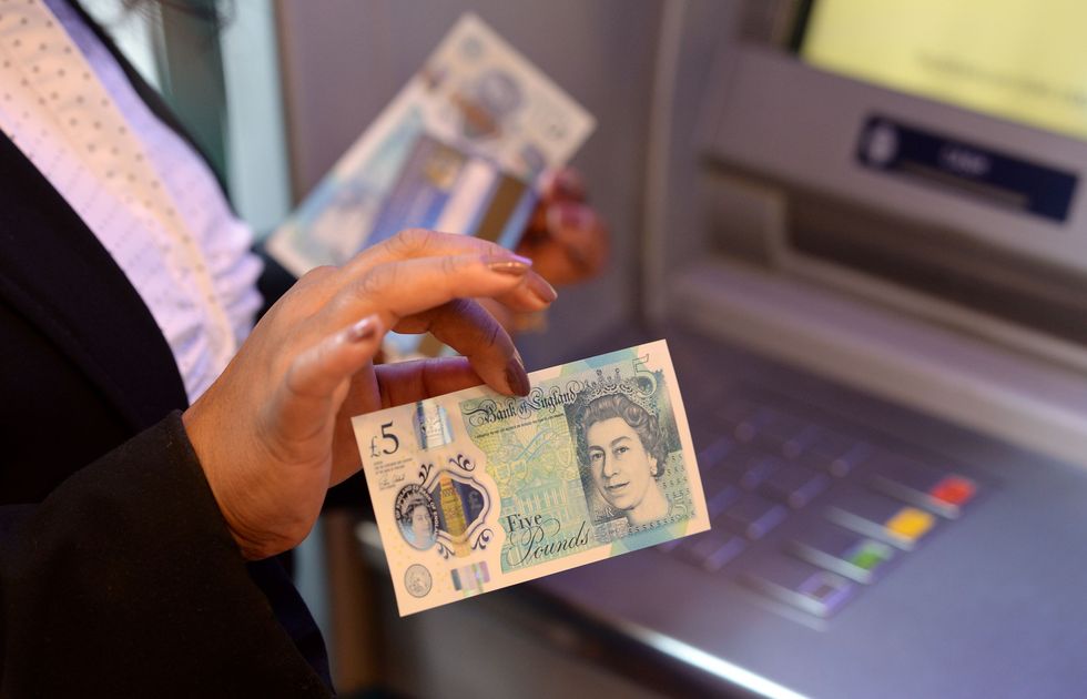 Kam Raju holds one of the first polymer \u00a35 note issued