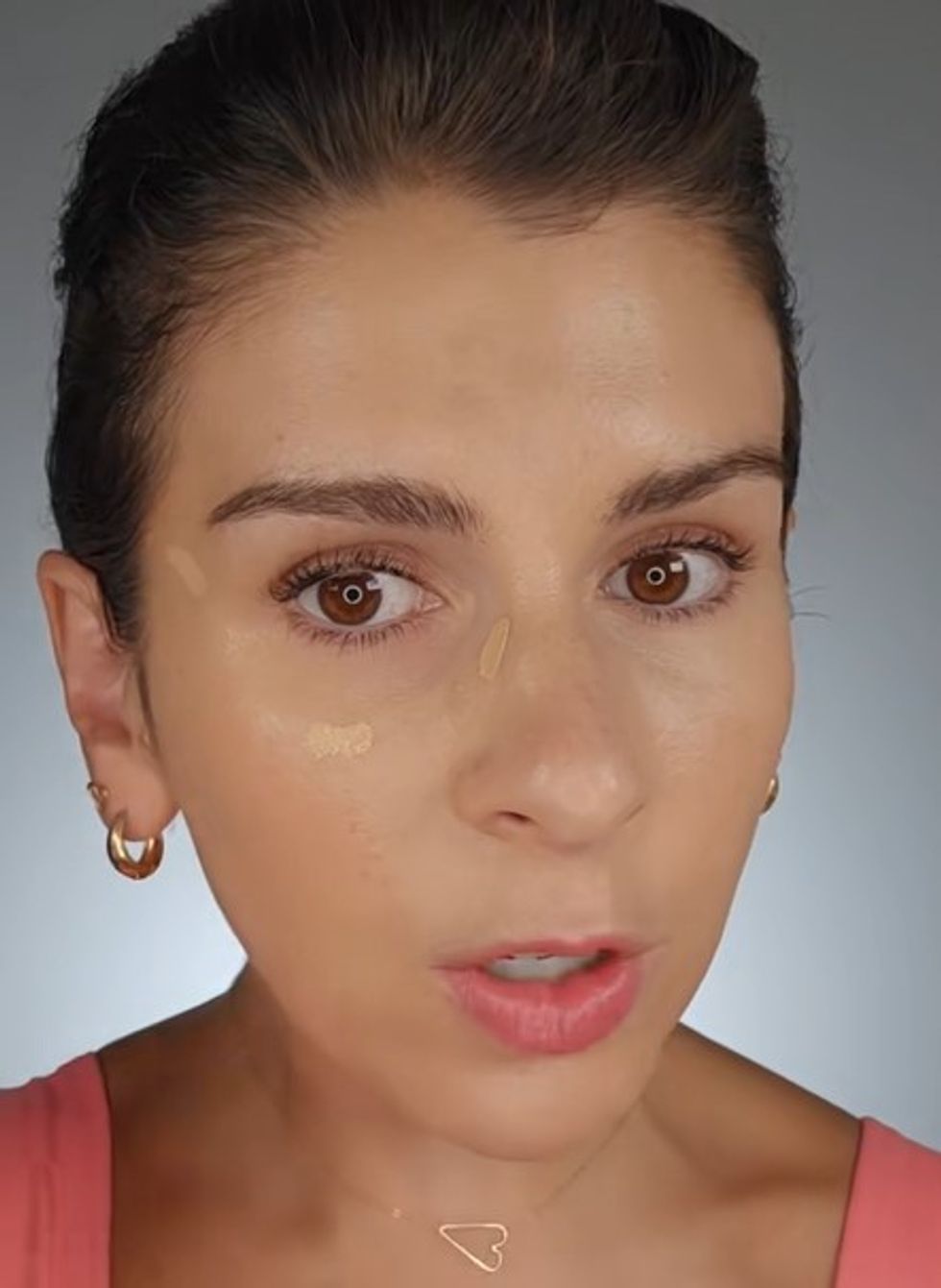 Kate demonstrating where to apply concealer