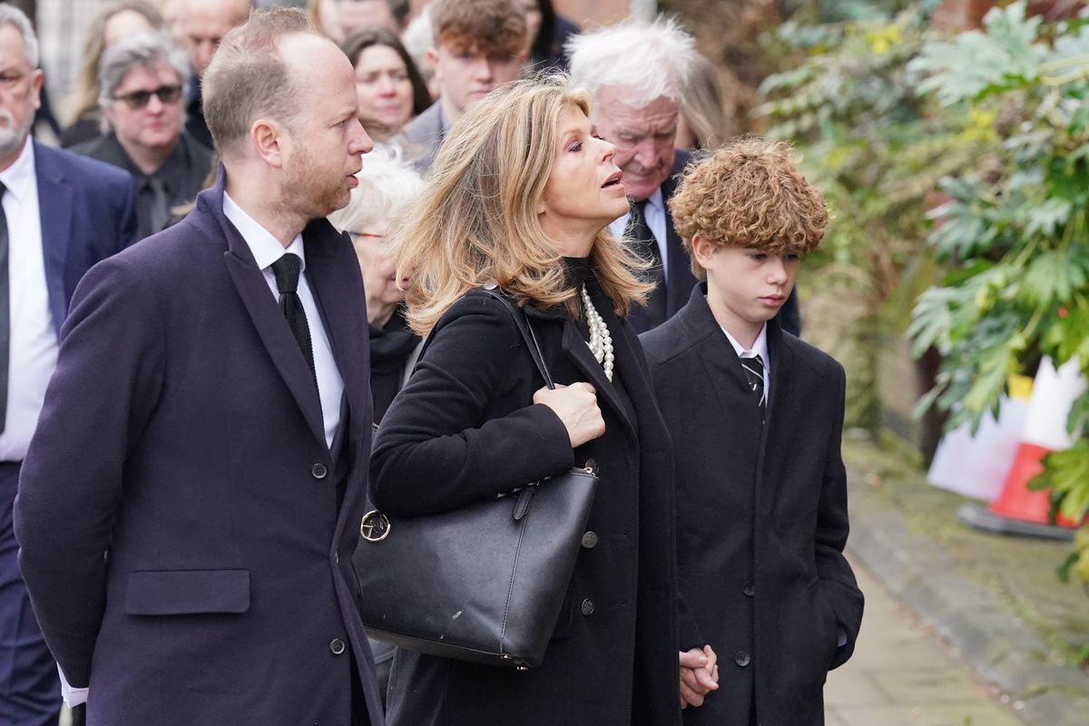 Kate Garraway holds her son's hand as she enters church
