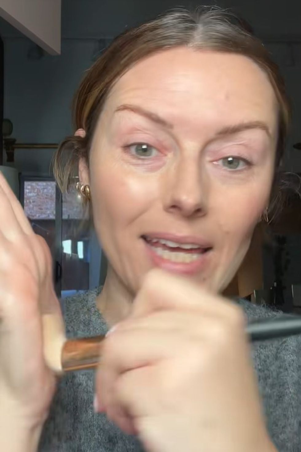 Katie Jane Hughes priming her makeup brush