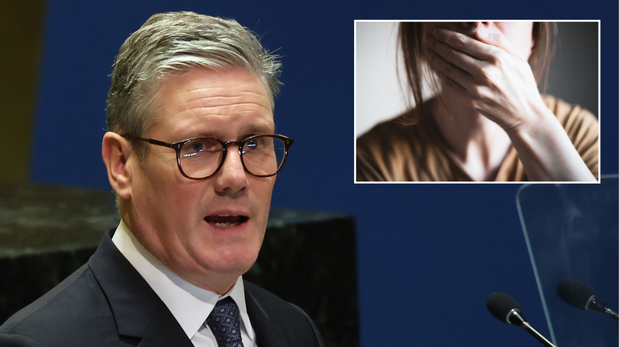 Keir Starmer and a woman holds her hand in front of her mouth