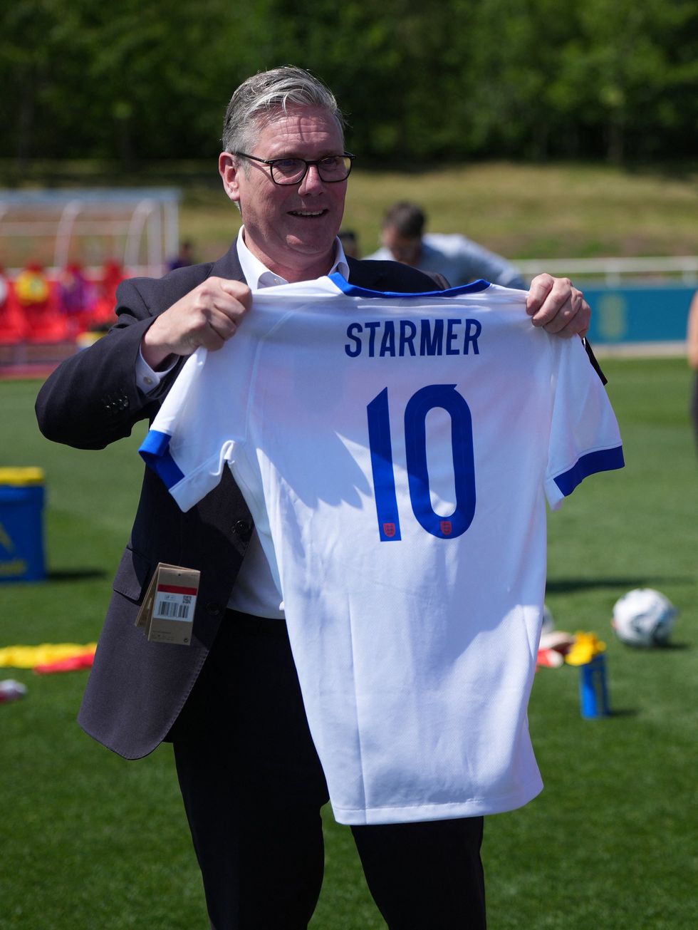 Keir Starmer holding England shirt