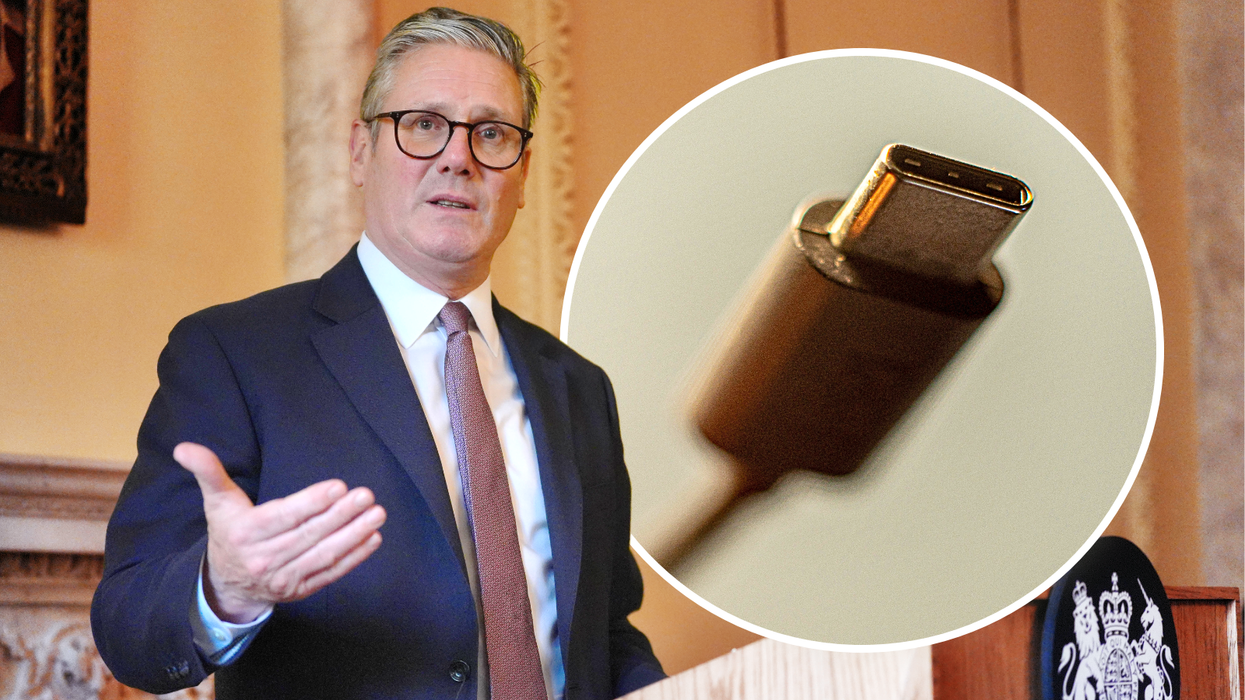 keir starmer standing behind a podium in downing street with an insert of a usb-c charger