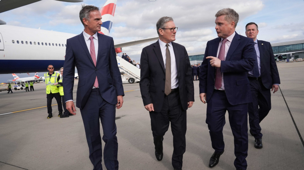 Keir Starmer with advisers before boarding plane to India