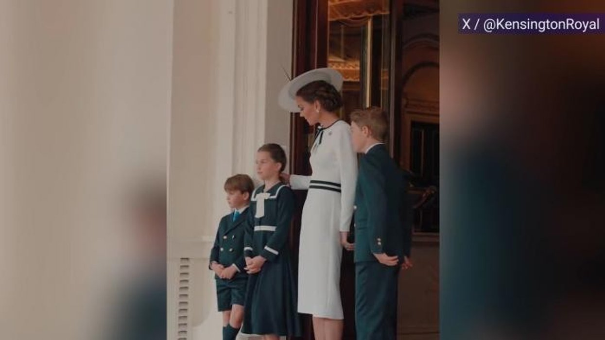 Buckingham Palace guard collapses and has to be carried away on a stretcher