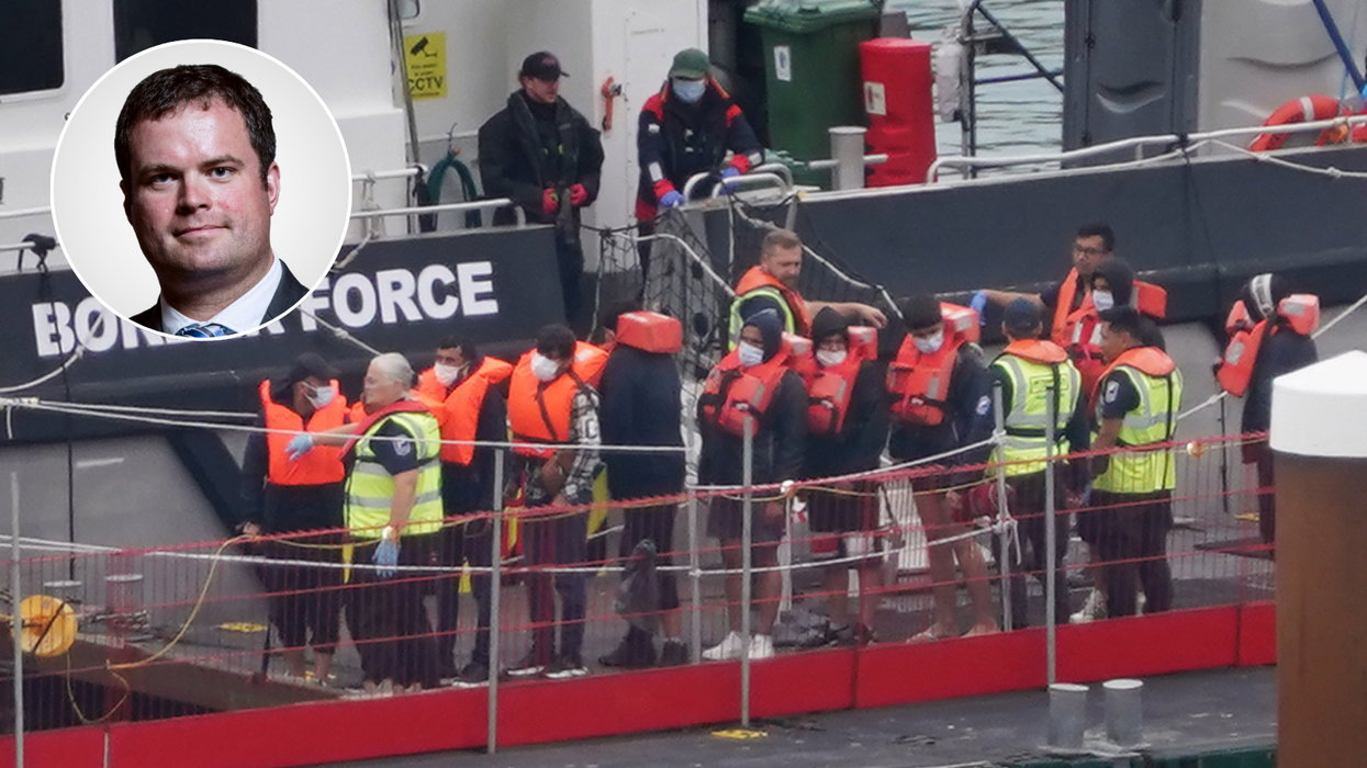 Kevin Foster and a group of people thought to be migrants arrive in Dover