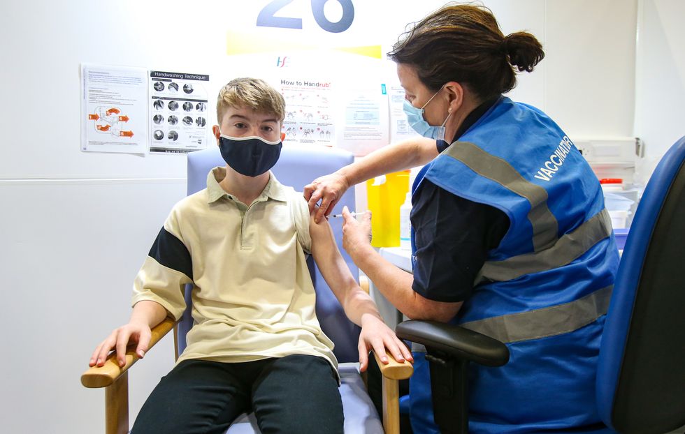 Kevin Mckeon, 14, receives his first dose of the Covid-19 vaccine