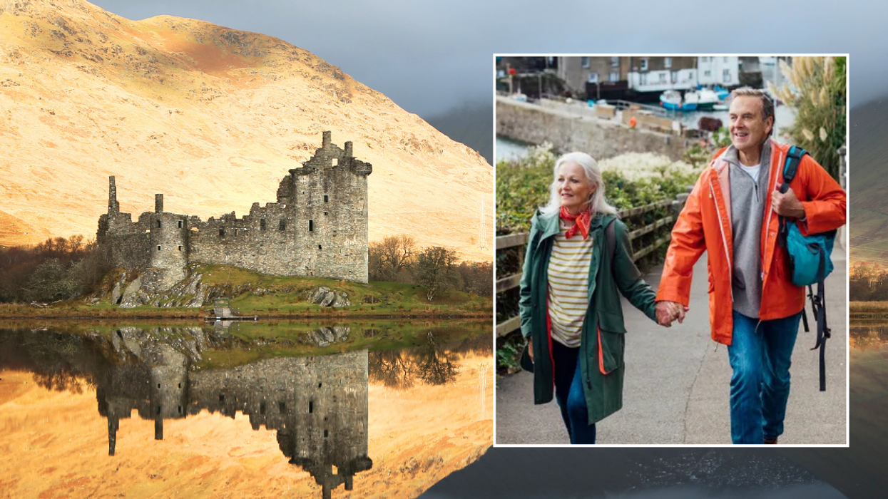 Kilchurn Castle Loch Awe / middle aged couple walking holding hands