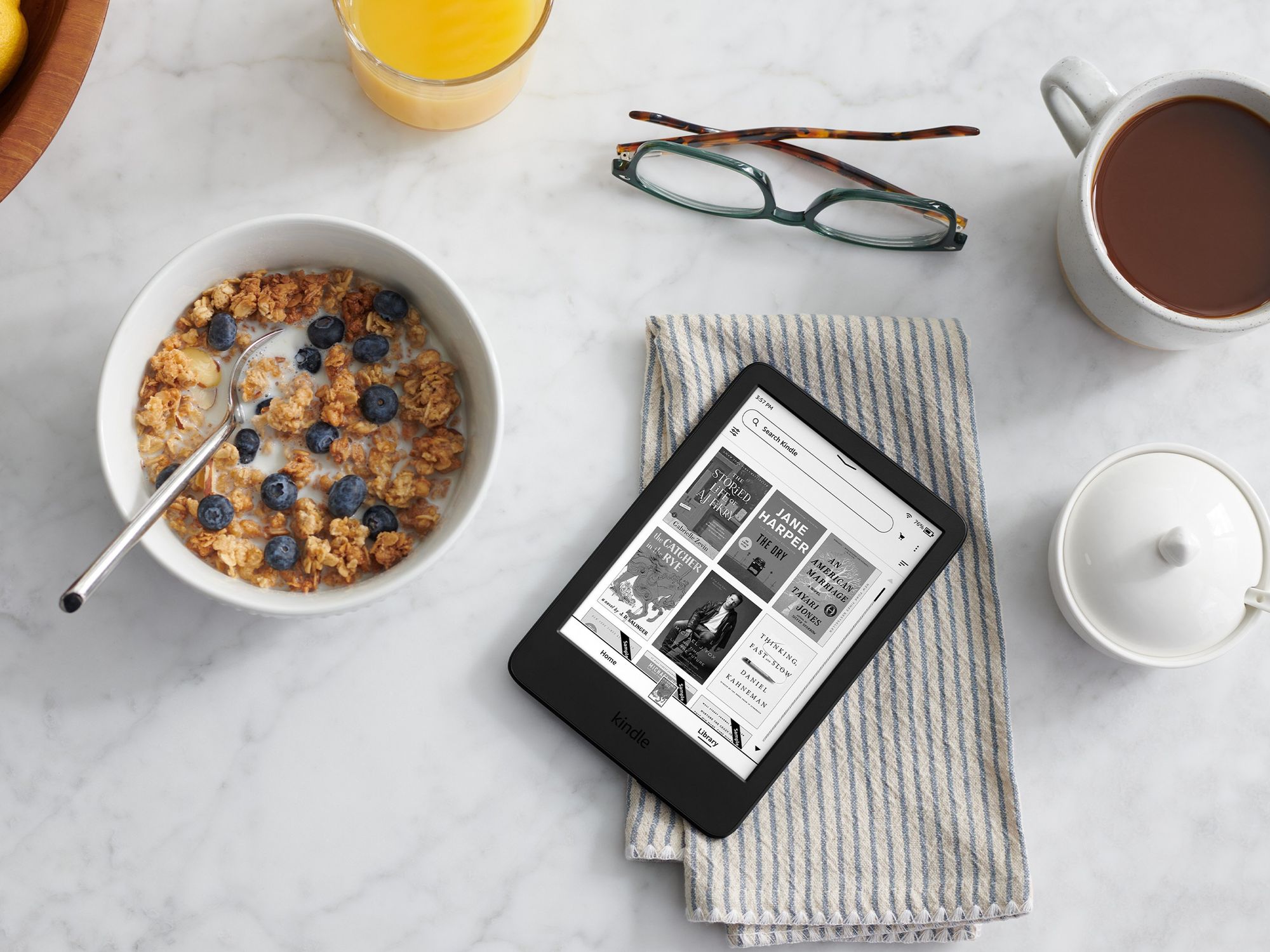 Kindle pictured on a breakfast table with cereal and coffee