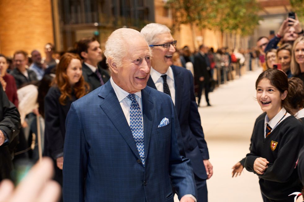 King Charles III and Apple CEO Tim Cook pictured laughing with children from the local St. George\u2019s Primary School