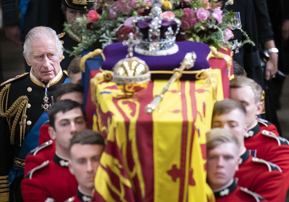 King Charles III and members of the royal family follow behind the coffin of Queen Elizabeth II, draped in the Royal Standard with the Imperial State Crown and the Sovereign's orb and sceptre, as it is carried out of Westminster Abbey after her State Funeral.