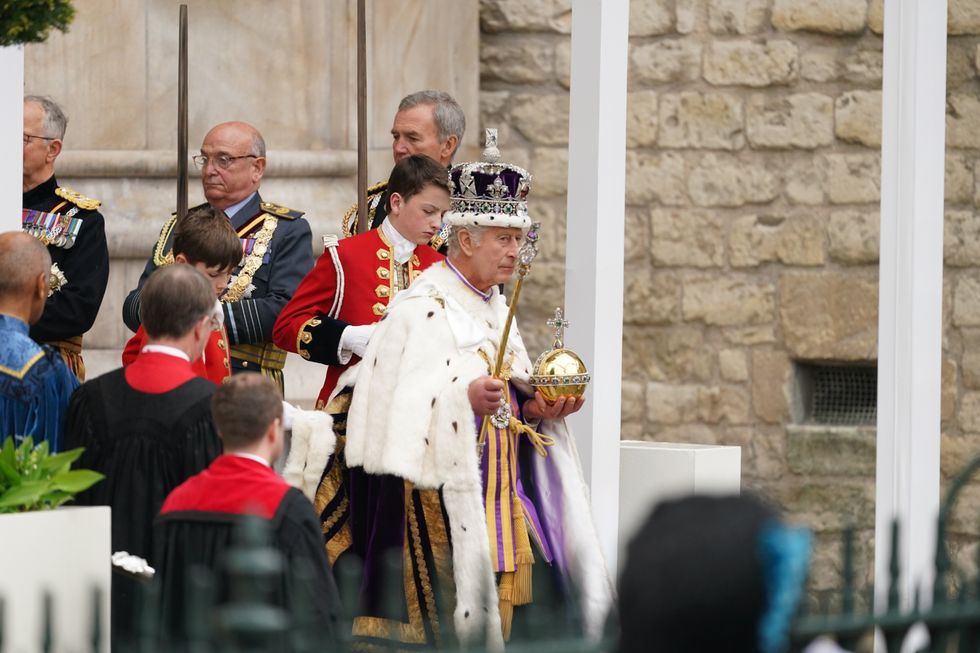 King Charles III leaves Westminster Abbey wearing the Imperial State Crown