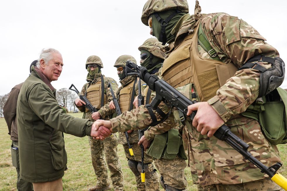 King Charles III meets with Ukrainian recruits during a visit to a training site for Ukrainian military recruits, in Wiltshire, where recruits are completing five weeks of basic combat training by British and international partner forces, before returning to fight in Ukraine. Picture date: Monday February 20, 2023.