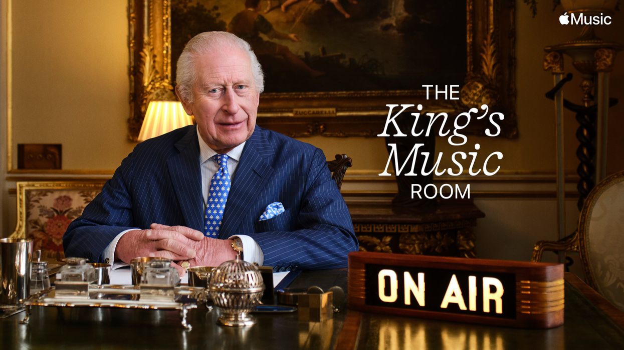 king charles iii pictured at his desk with an on-air message on the desk