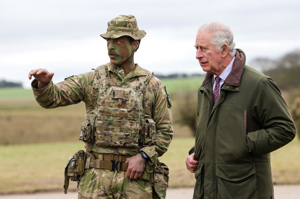 King Charles III (right) meets Major Tony Harris ahead of a trench attack and defence simulation during a visit to a training site for Ukrainian military recruits, in Wiltshire, where recruits are completing five weeks of basic combat training by British and international partner forces, before returning to fight in Ukraine. Picture date: Monday February 20, 2023.