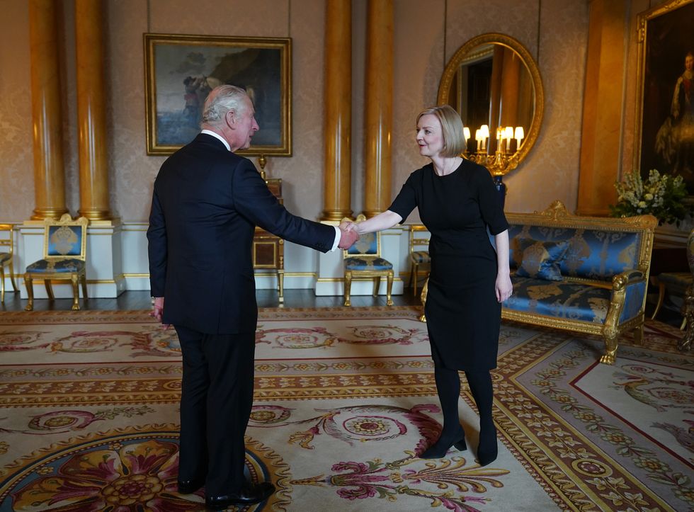 King Charles III shakes hands with Prime Minister Liz Truss during their first audience at Buckingham Palace