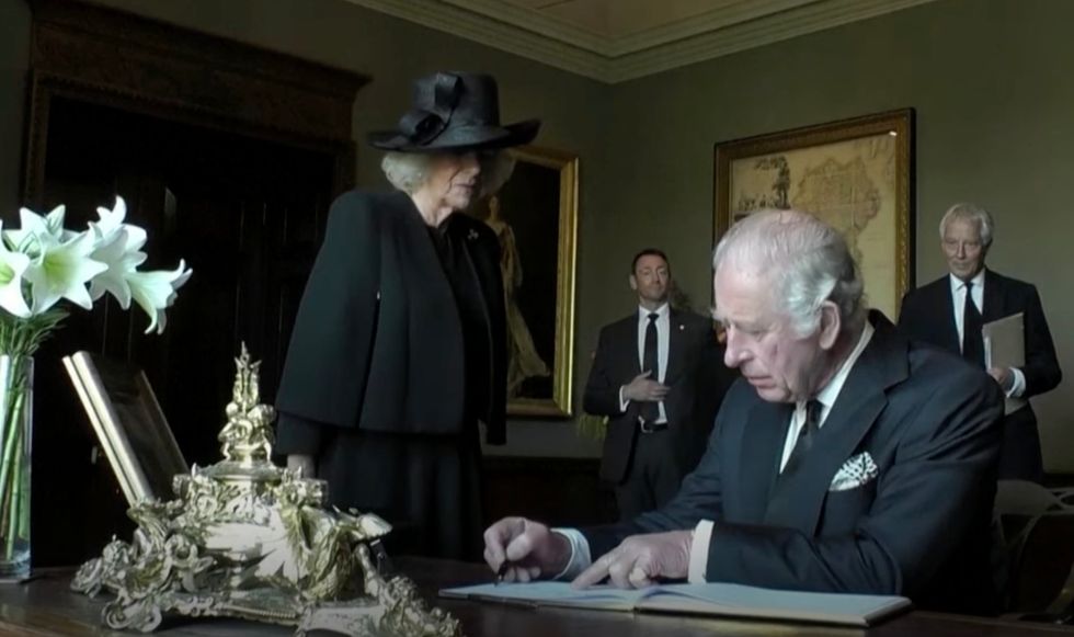 King Charles III using the pen on Tuesday