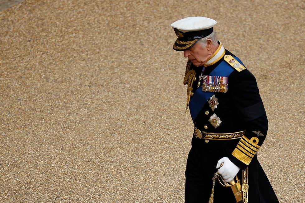 King Charles III walks through Windsor Castle ahead of a Committal Service at St George's Chapel for Queen Elizabeth II.