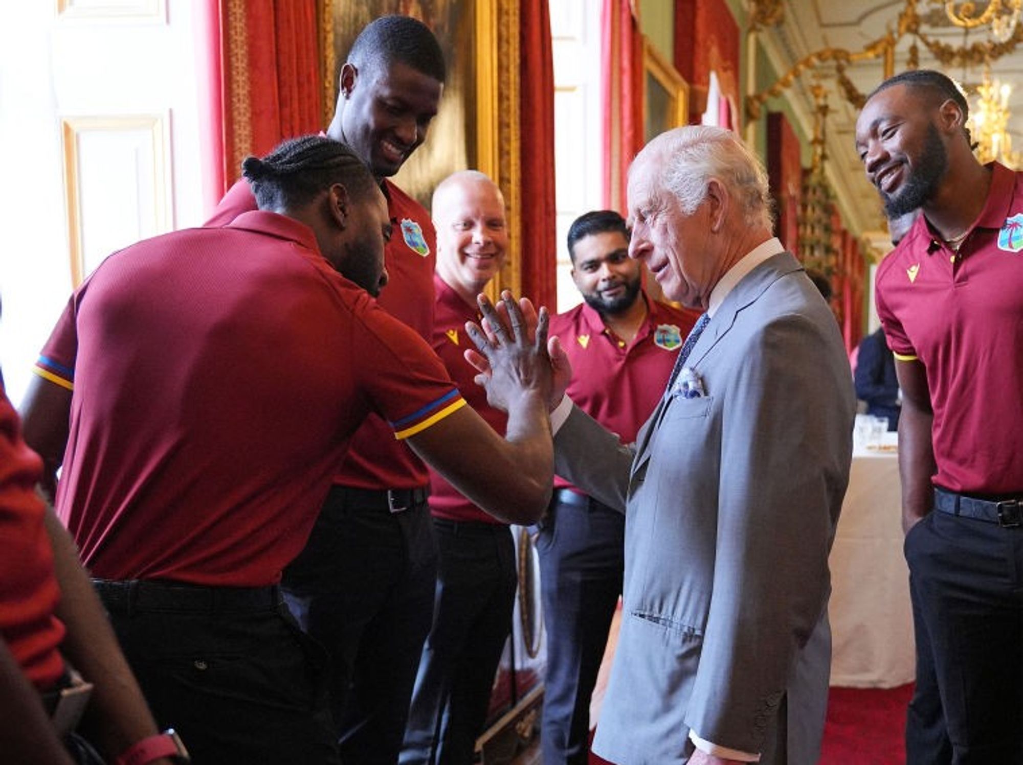 King Charles learning Caribbean hand gestures