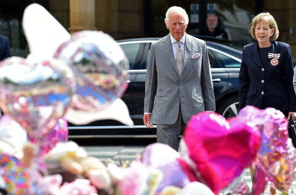 King Charles looking at tributes in Southport