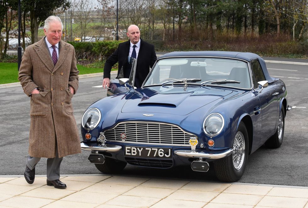 King Charles with his Aston Martin, which is powered by wine and cheese