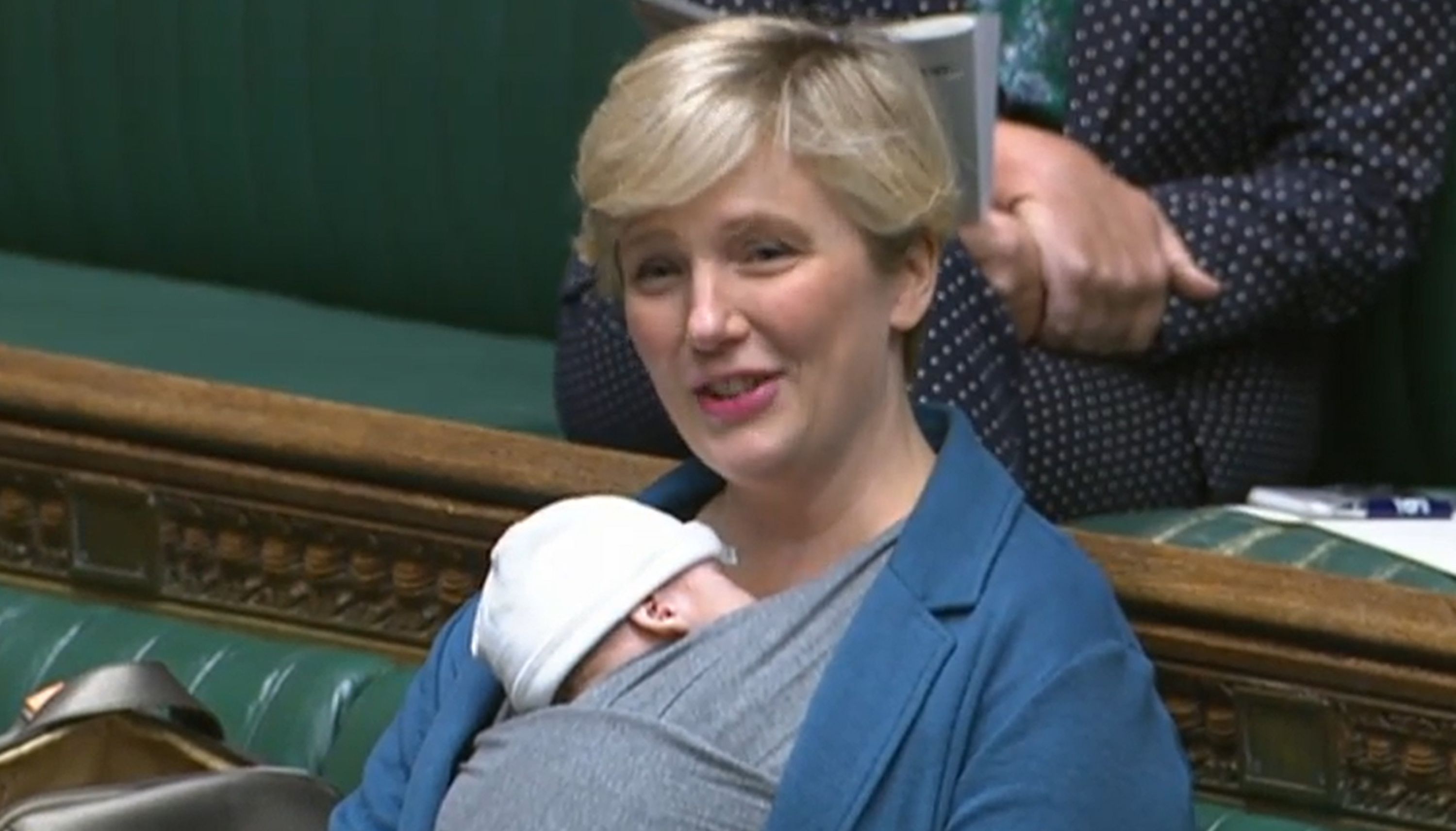 Labour MP Stella Creasy speaking in the chamber of the House of Commons, in London, with her newborn baby strapped to her.