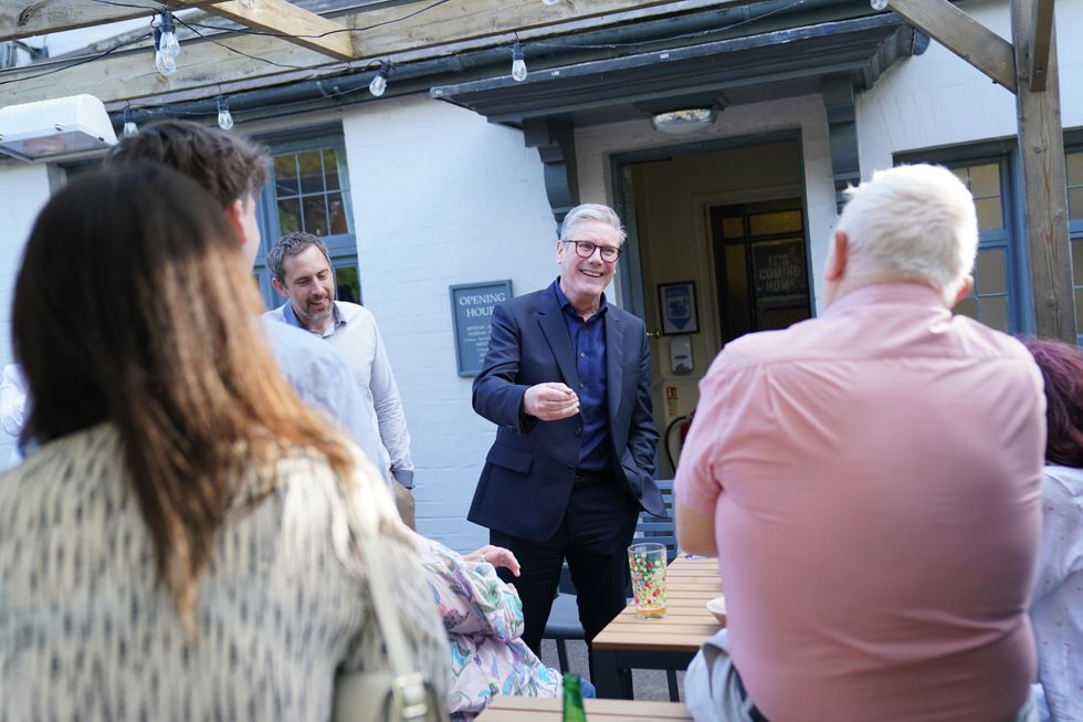 Labour Party leader Sir Keir Starmer speaks with party activists at the Dusty Miller pub in Harlow, Essex