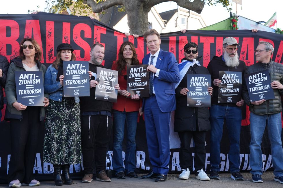 Laila Cunningham (middle left) and Richard Tice (middle right) with protests holding placards which read 'anti-zionism = terrorism'