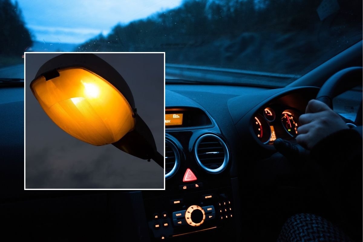Lamppost and a man driving a car at night