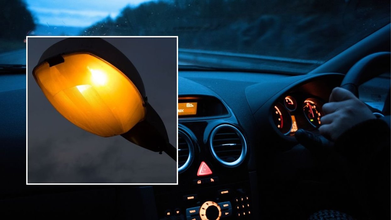 Lamppost and a man driving a car at night