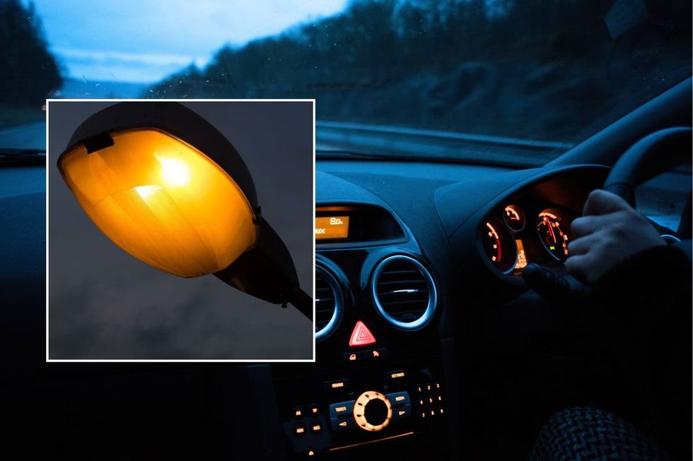 Lamppost and a man driving a car at night