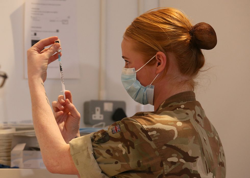 Lance corporal (LCpl) Amy Portman loads an injection of a coronavirus vaccine whilst assisting with the vaccination programme at the Royal Highland Showground near Edinburgh. Picture date: Thursday February 4, 2021.